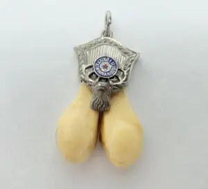 Ornate pendant with yellow tusk design.