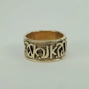 Gold ring with intricate engraved design.