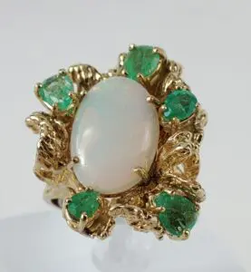 Gold ring with opal and green stones.