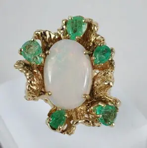 Gold ring with opal and green stones.