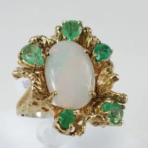 Gold ring with opal and emerald stones.
