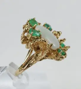 Gold ring with opal and emerald stones.