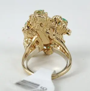 Gold ring with intricate, leafy design.