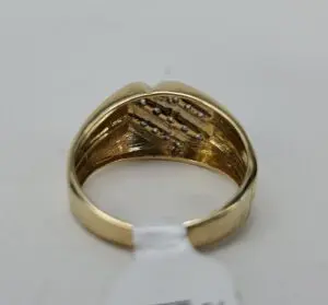Gold ring with diamond accents inside band.