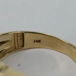 14K gold ring engraving close-up.