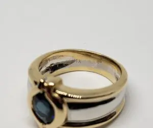 Gold and silver ring with blue gemstone.