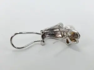 Silver earring with pearl and clasp.