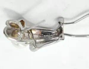 Silver metal rabbit figure with wire frame.