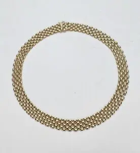 Gold chain necklace on white background.
