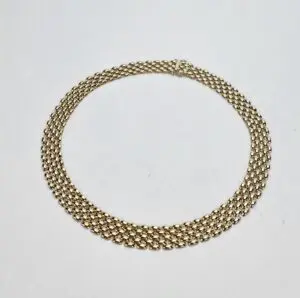 Gold chain necklace on white background.