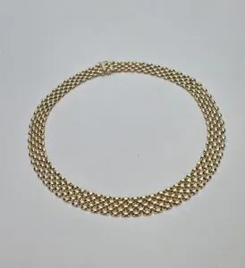 Gold chain necklace on white background.