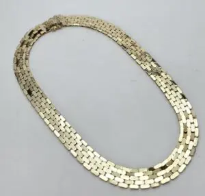 Gold chain necklace on white background.