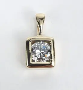 Gold pendant with square-cut diamond stone.