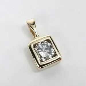 Gold pendant with square diamond setting.