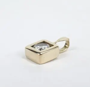 Gold pendant with square gemstone setting.