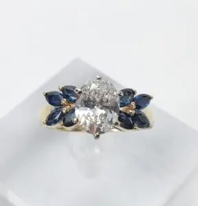 Gold ring with diamond and blue stones.