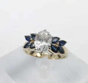 Gold ring with diamond and blue stones.