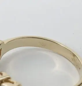 Gold ring with "14K" engraving inside band.