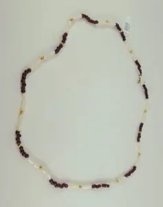 Red and white beaded necklace on display.