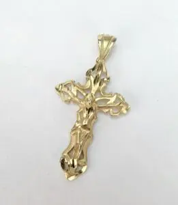 Gold crucifix pendant on white background.