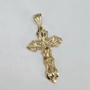 Gold crucifix pendant on white background.