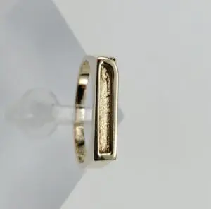 Gold ring with rectangular design detail.