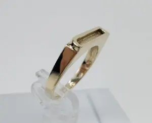 Gold ring with modern geometric design.