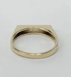 Gold ring with flat top design.