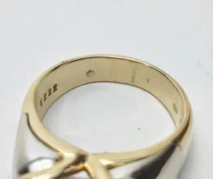 Gold ring with engraved markings inside.
