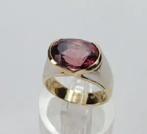 Gold ring with a large red gemstone.