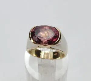 Gold ring with large red gemstone.
