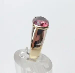 Gold ring with a pink gemstone.