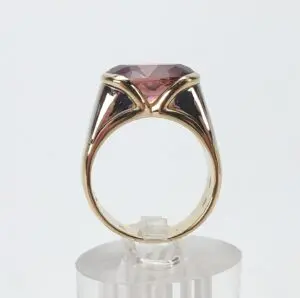 Gold ring with large red gemstone.