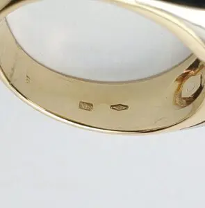 Gold ring with visible hallmarks inside band.