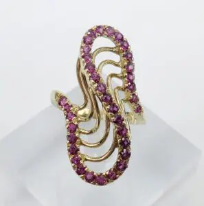 Gold ring with pink gemstone design.