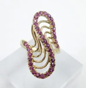 Gold ring with purple gemstone accents.