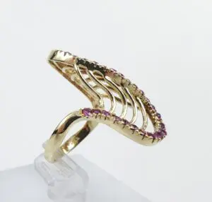 Gold ring with pink gemstone accents.