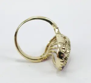Gold ring with intricate decorative design.