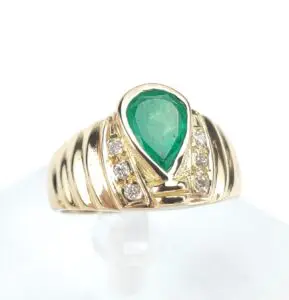 Gold ring with emerald and diamonds.