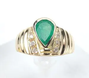 Gold ring with emerald and diamonds.
