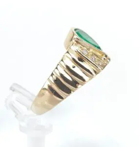 Gold ring with green gem and diamonds.