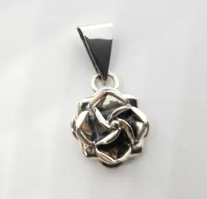 Silver rose pendant on white background.