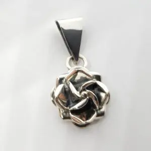 Silver rose pendant on white background.