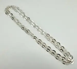 Silver chain necklace on white background.