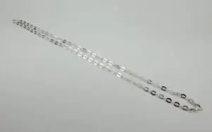 Silver chain necklace on white background.