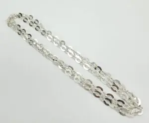 Silver chain necklace on white background.