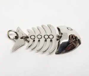 Metal fishbone-shaped keychain on white background.