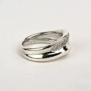 Silver ring with textured design on band.