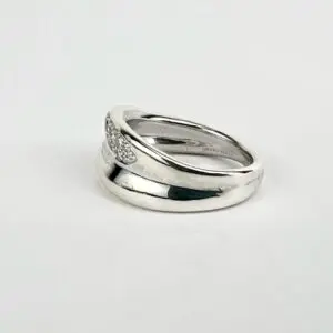 Silver ring with diamond accents on white.