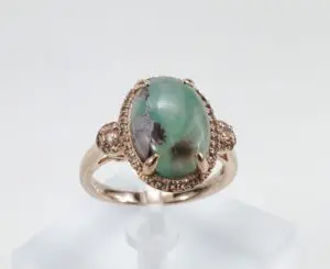 Gold ring with a large turquoise stone.
